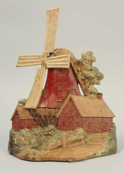 CAST IRON WINDMILL WITH 2 COTTAGES DOORSTOP.      