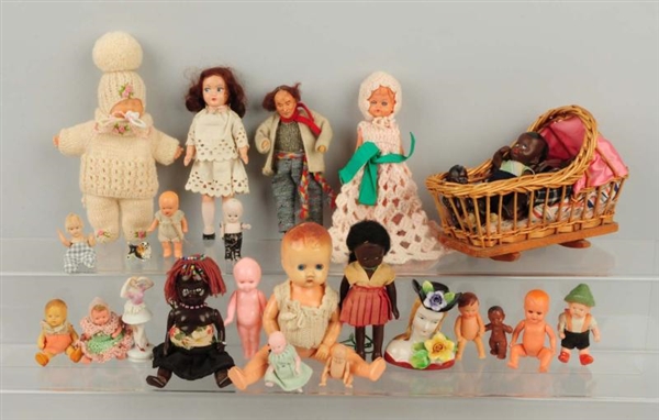LOT OF 25: ASSORTED DOLLS AND CRADLE.             
