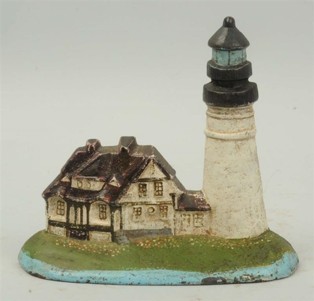 CAST IRON LIGHTHOUSE WITH KEEPERS HOUSE DOORSTOP. 