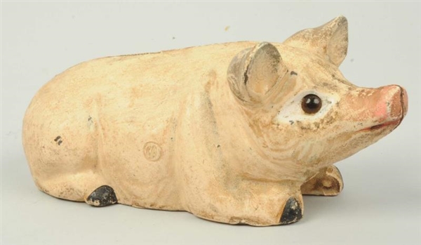 CAST IRON LYING DOWN PIG WITH GLASS EYES BANK.    
