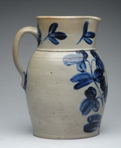STONEWARE PITCHER WITH FLORAL MOTIF.              