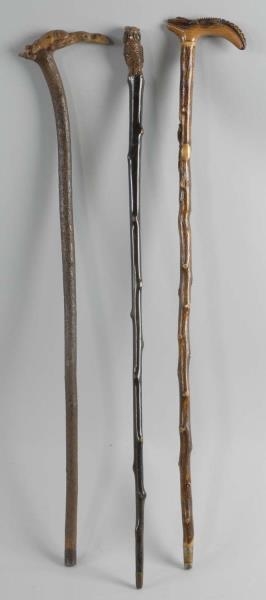 LOT OF 3: CANES WITH CARVED HANDLES.              