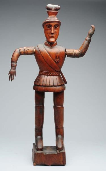 CARVED WOODEN STATUE OF GERMAN MAN.               