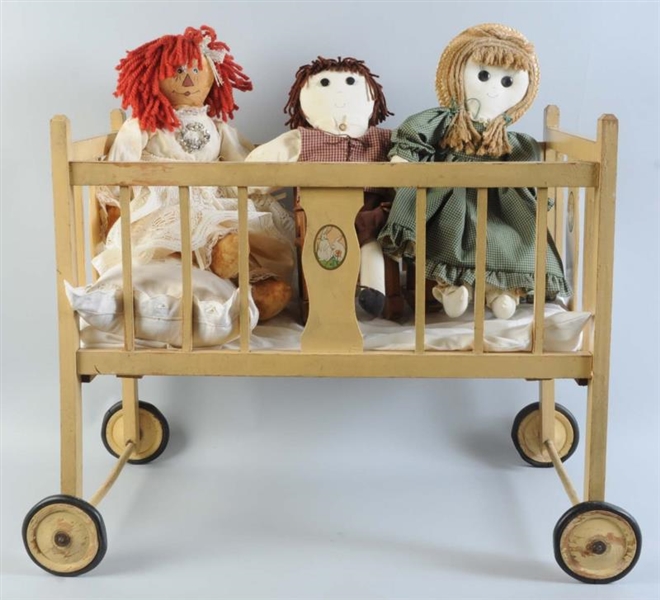 LOT OF 3: CLOTH DOLLS IN A VINTAGE WOODEN CRADLE. 
