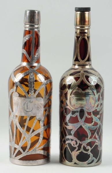 LOT OF 2: BOTTLES WITH SILVER OVERLAY.            
