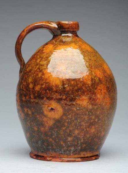 EARLY REDWARE GREEN SPECKLED JUG.                 