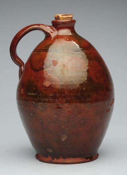 EARLY OVOID REDWARE JUG.                          