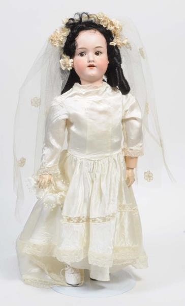BISQUE DOLL WITH CREAM DRESS.                     