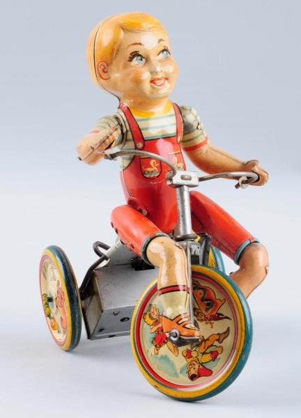 UNIQUE ART TIN WIND-UP KIDDY CYCLIST.             