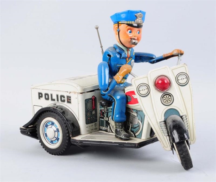 BATTERY - OPERATED TIN POLICE TRICYCLE.           