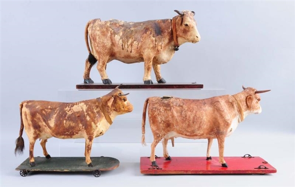 LOT OF 3 COWS ON WHEELED BASES.                   