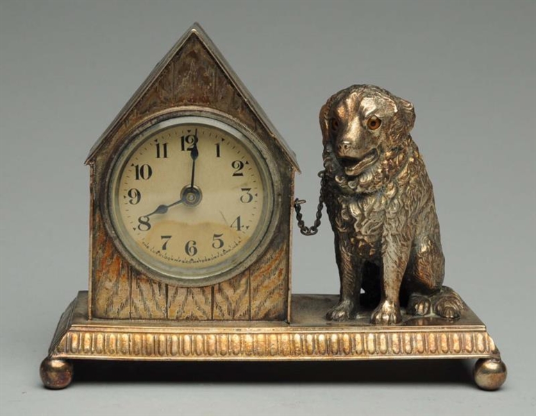 SILVER OVER COPPER CLOCK WITH DOG.                