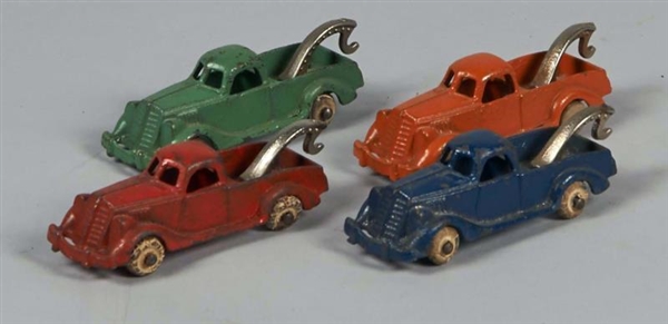 LOT OF 4 EARLY CAST IRON HUBLEY TOW TRUCKS        