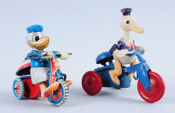 LOT OF 2: DONALD DUCKS WIND UP TRICYCLE TOYS.     