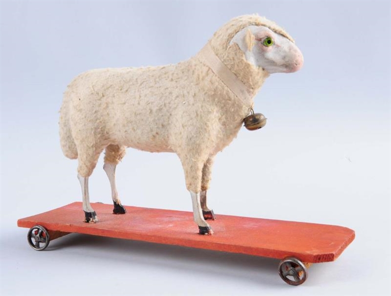 WOODEN AND CLOTH SHEEP ON WHEELS.                 