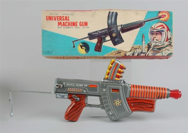 TIN BATTERY-OPERATED UNIVERSAL MACHINE GUN & BOX. 