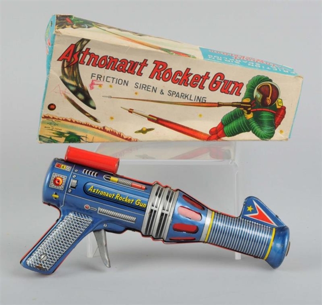 TIN ASTRONAUT ROCKET GUN IN ORIGINAL BOX.         
