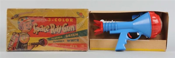 PLASTIC SPACE RAY GUN IN ORIGINAL BOX.            