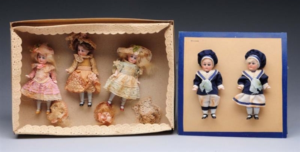LOT OF 2: SETS OF REPRODUCTION DOLLS.             