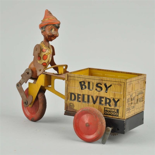 TIN LITHO WIND-UP BUSY DELIVERY TOY.              