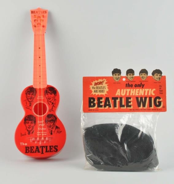 BEATLES TOY GUITAR AND WIG.                       