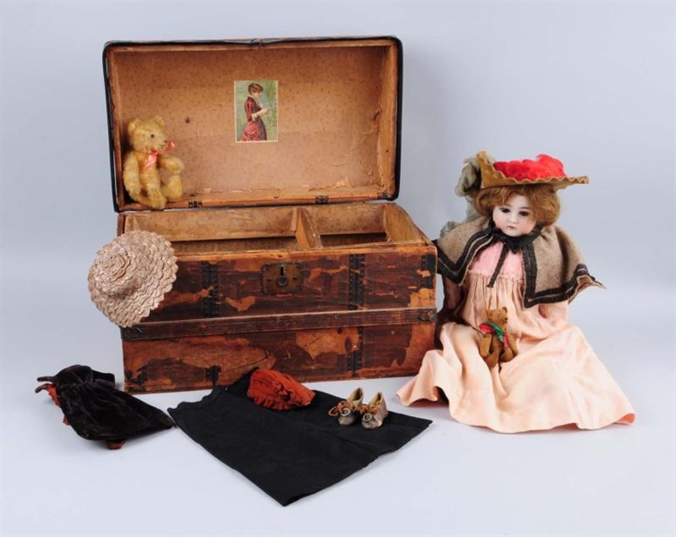 PORCELAIN DOLL WITH TRUNK AND CLOTHES.            