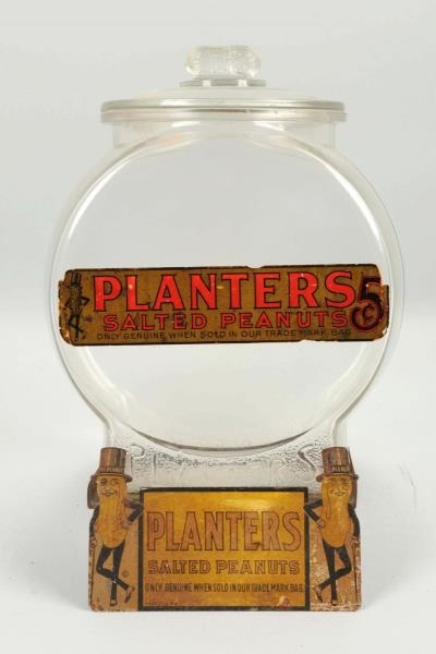 PLANTERS PEANUTS JAR WITH TIN SIGN STAND.         