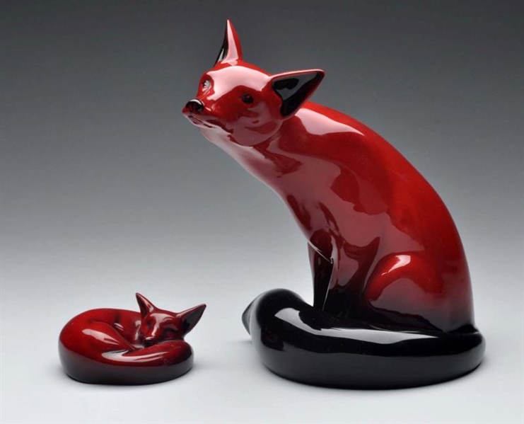 PAIR OF ROYAL DOULTON RED FLAMBE FOXES.           