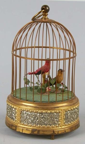 WIND-UP BIRDS IN WIRE CAGE                        