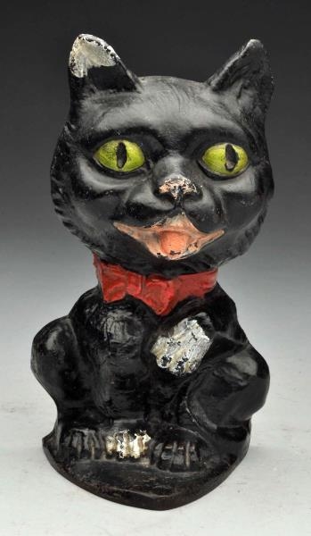 CAST IRON WHIMSICAL CAT WITH PAW UP DOORSTOP.     