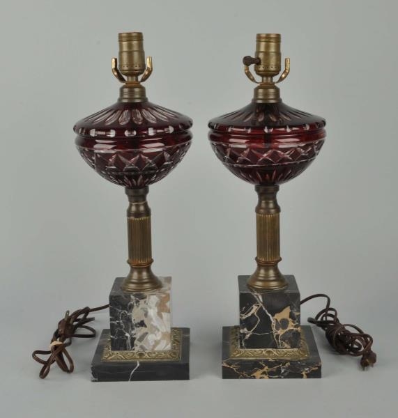 PAIR OF CUT CRANBERRY GLASS LAMPS.                
