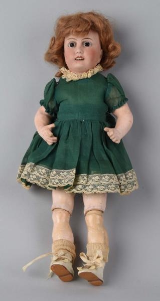 BISQUE HEAD DOLL WITH RED HAIR.                   