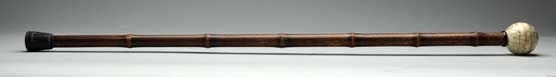 WOODEN CANE WITH IVORY GLOBE HANDLE.              