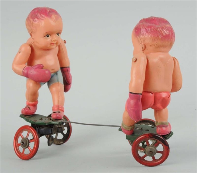 CELLULOID WIND-UP BABY BOXER TOY.                 