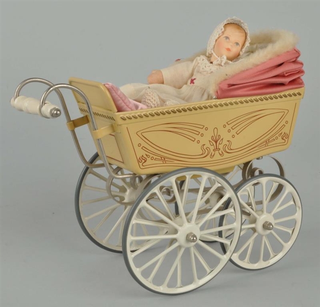 TIN TOY BABY CARRIAGE WITH DOLL.                  