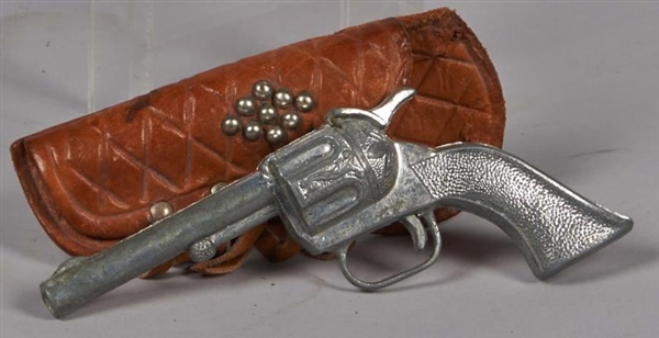 SMALL TOY REVOLVER IN LEATHER FRINGED HOLSTER     