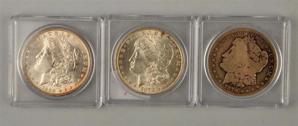 LOT OF 3:  MORGAN SILVER DOLLARS IN CASES.        