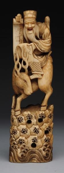 JAPANESE CARVED IVORY MAN ON STAG FIGURE.         