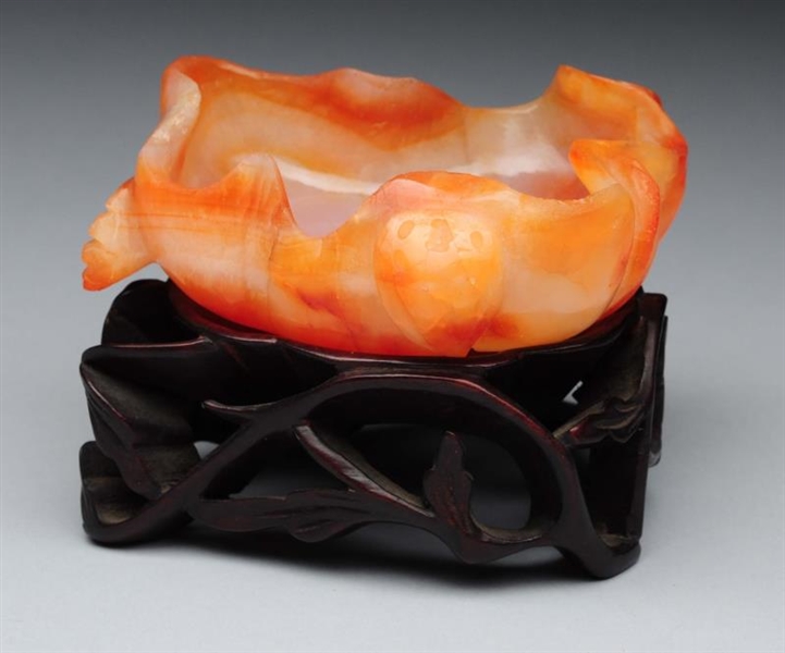 CHINESE CARVED CARNELIAN DISH ON STAND.           