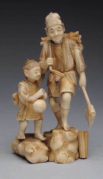 EARLY JAPANESE IVORY CARVING MAN WITH BOY.        