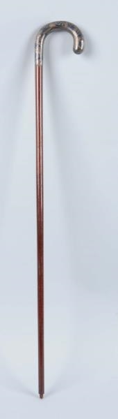CANE WITH CURVED  METAL ETCHED HANDLE.            