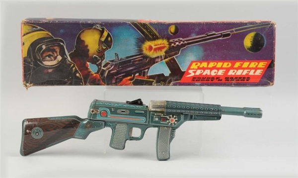 TIN LITHO RAPID FIRE SPACE RIFLE IN BOX.          