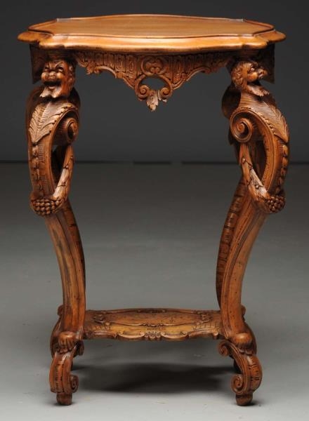 SMALL CARVED WOODEN STAND WITH LAUGHING FACES.    