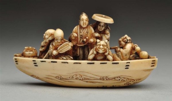 CARVED NETSUKE BOAT WITH FIGURES.                 