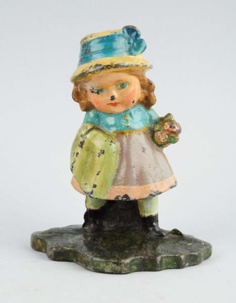 CAST IRON GIRL HOLDING SCARF AND FLOWERS DOORSTOP.