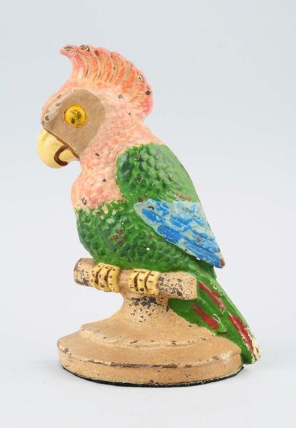CAST IRON POLLY PARROT ON PERCH DOORSTOP.         