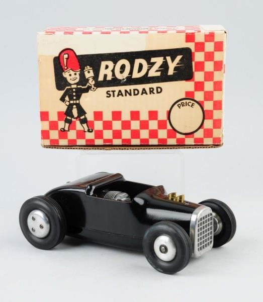 PRESSED STEEL CAMERON RODZY RACE CAR IN BOX.      
