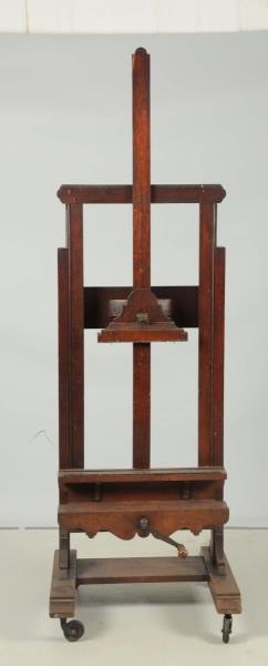 LARGE WOODEN PICTURE HOLDER ON WHEELS.            