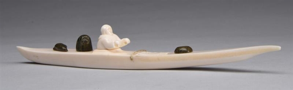 ANTIQUE INUIT IVORY CANOE CARVING.                