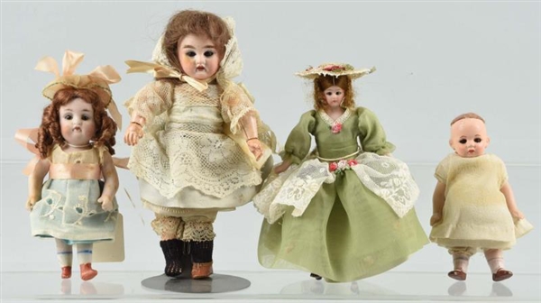 LOT OF 4: SMALL ANTIQUE BISQUE HEAD DOLLS.        